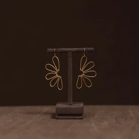 Gold handcrafted hoop earrings on a white background